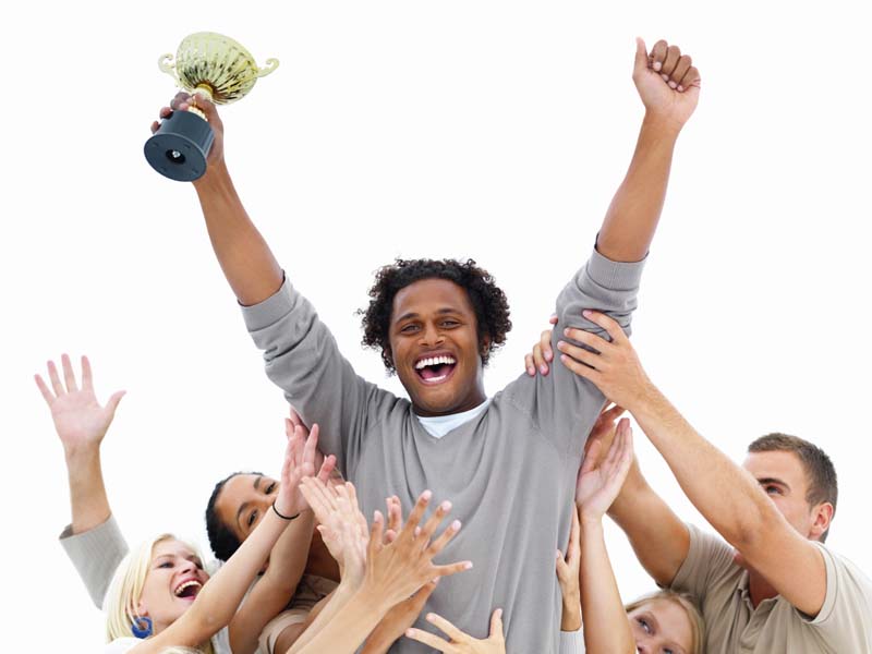 Young man standing above the crowd victorious